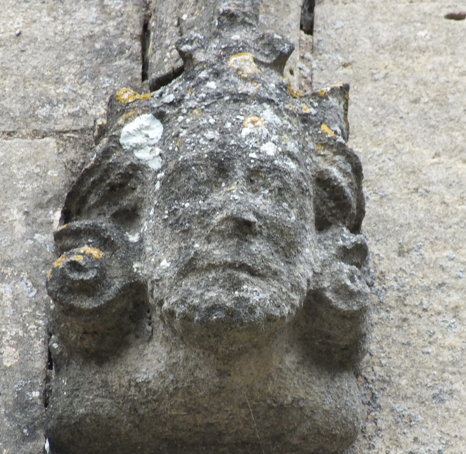Weathered crowned head carved on the exterior of St Andrew’s Church, Heckington